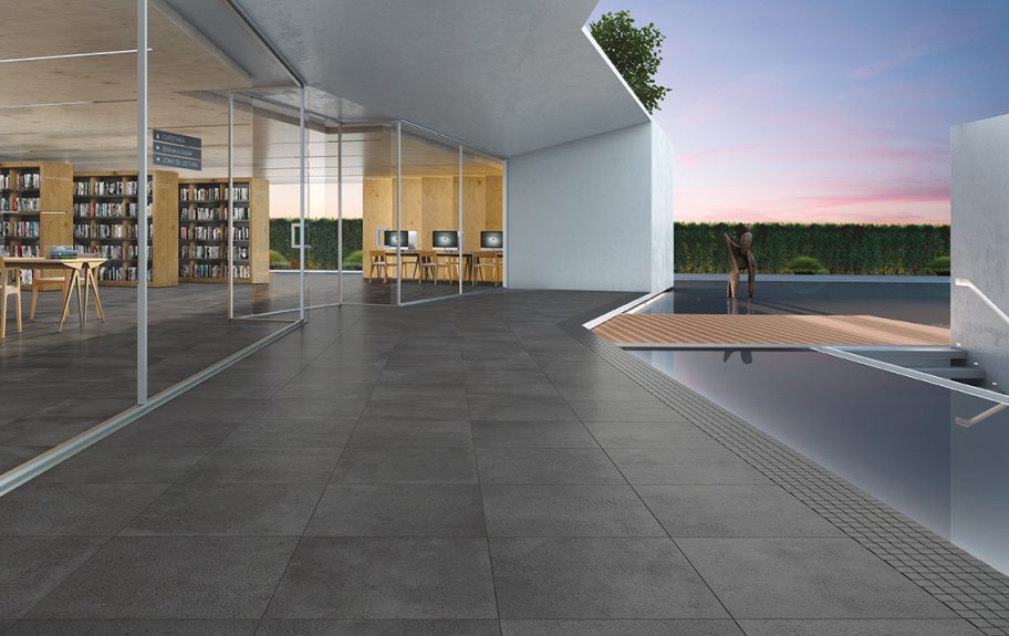 Cerâmica com efeito de cimento Grand Stone da Recer, aplicado no chão de um espaço exterior moderno.