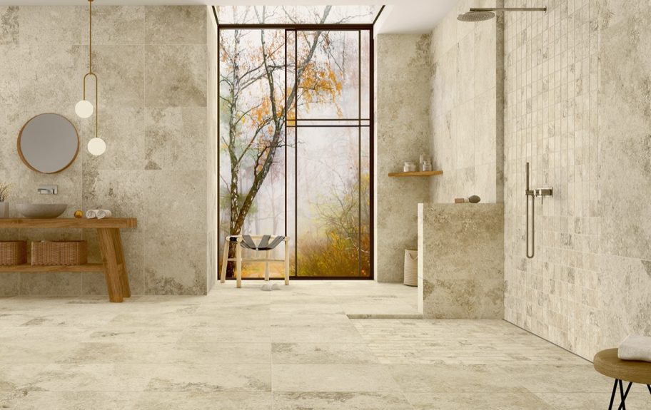 Cerâmica com efeito de pedra natural Rapolano Sand da Recer, numa casa de banho ampla e elegante.