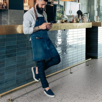 Handsome,Barista,Using,Mobile,Phone,In,A,Cafe.,Serious,Waiter