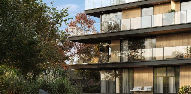 Building facade with Legacy Oak Ripple cladding creating a vertical ribbed wood effect, showcased on modern balconies with large glass panels and surrounded by landscaped greenery. Ideal architectural application of Recer ceramic wood look tiles.