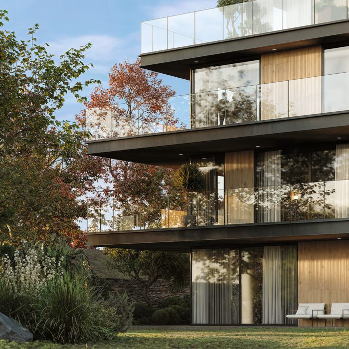 Building facade with Legacy Oak Ripple cladding creating a vertical ribbed wood effect, showcased on modern balconies with large glass panels and surrounded by landscaped greenery. Ideal architectural application of Recer ceramic wood look tiles.